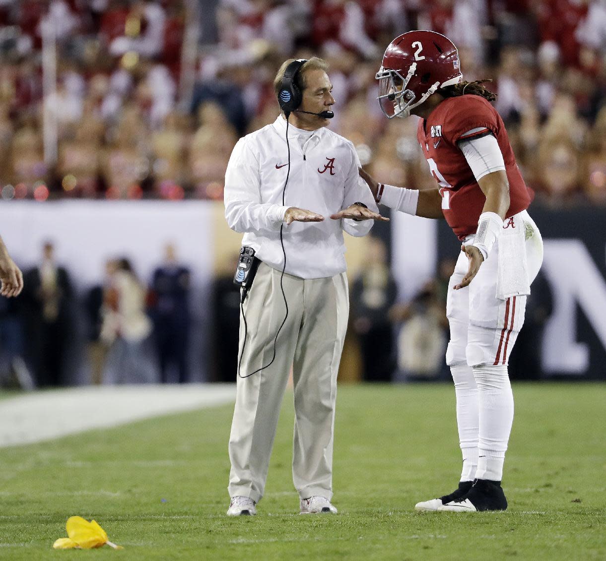 Nick Saban talks to Jalen Hurts during the first half of the NCAA college football playoff championship game against Clemson Monday, Jan. 9, 2017, in Tampa, Fla. (AP)