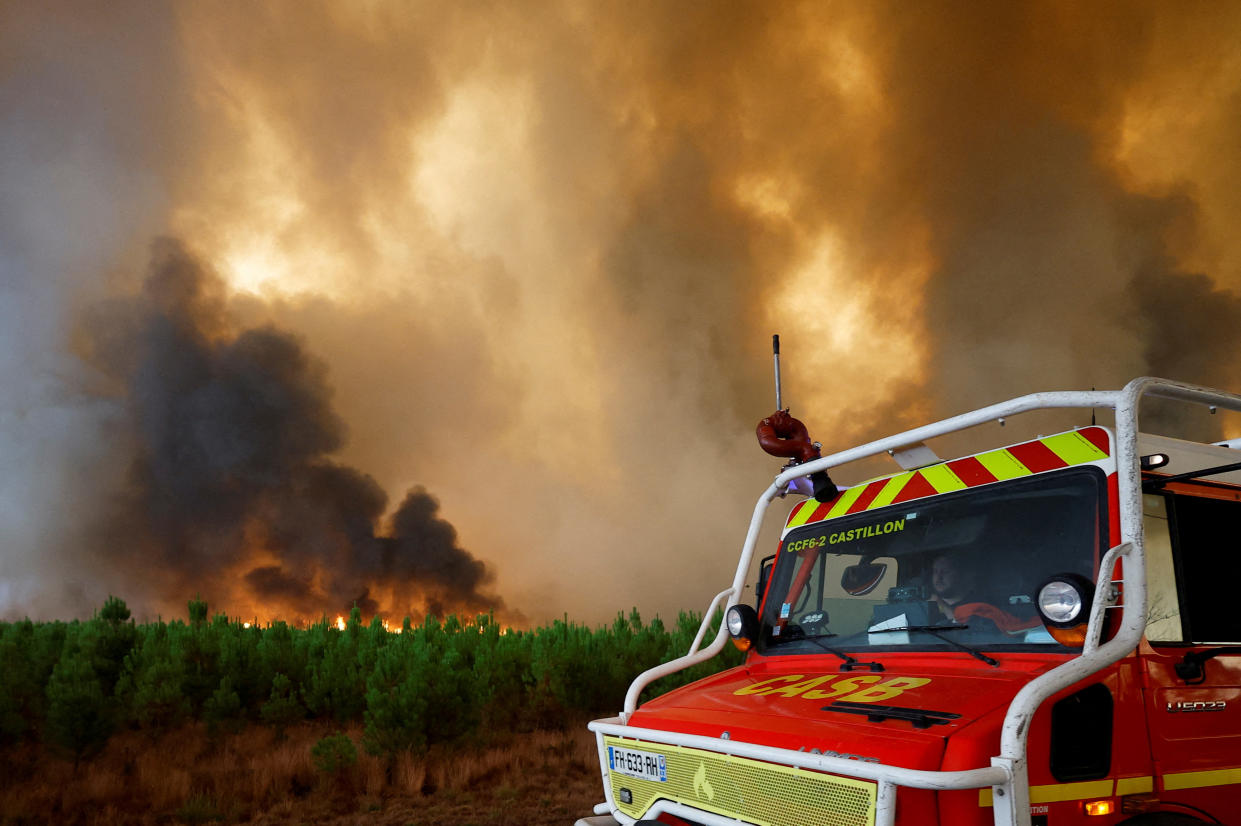 Firefighters work to contain a fire in Belin-Beliet, as wildfires continue to spread in the Gironde region of southwestern France, August 10, 2022. REUTERS/Stephane Mahe