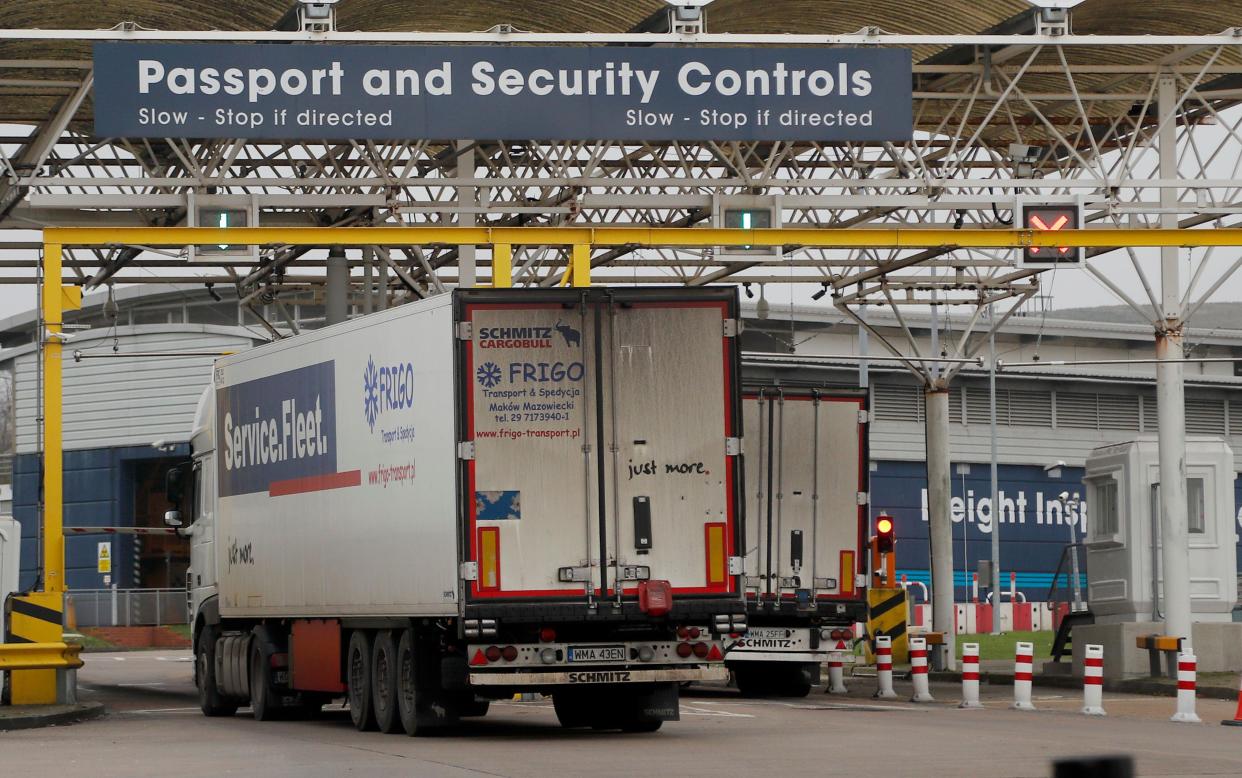 FILE - Lorries pass the customs checkpoint at the Eurotunnel link with Europe in Folkestone, England, Friday, Jan. 1, 2021. Britain’s departure from the European Union has brought higher costs, more red tape and border delays for businesses, and not yet delivered promised benefits, a public spending watchdog said Wednesday, Feb. 9, 2022. (AP Photo/Frank Augstein, File)