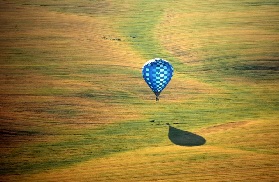 A hot air balloon flies over the outskirts of Minsk, Belarus, during the second International Aeronautics Championship on July 18.