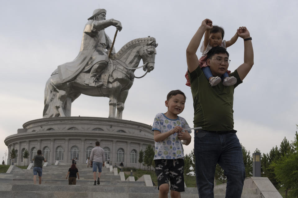 Tourists visit the 40-meter (130-foot-) tall stainless steel statue of Genghis Khan, a national hero who amassed power to become the leader of the Mongols in the early 13th century, on the outskirts of Ulaanbaatar, Mongolia, Monday, July 1, 2024. (AP Photo/Ng Han Guan)