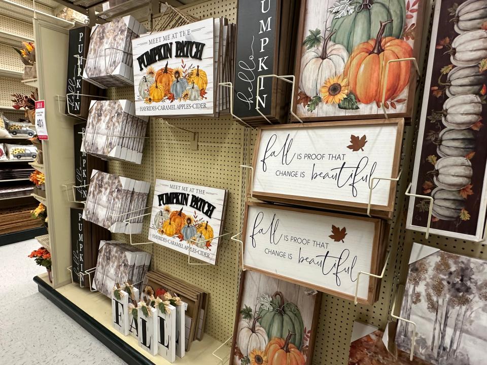 Wall art with pumpkins and inspiring quotes on display at Hobby Lobby