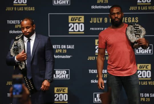 UFC president Dana White stars between Daniel Cormier (L) and Jon Jones as they square off during a media availability for UFC 200 at Madison Square Garden on April 27, 2016 in New York City. (Photo by Jeff Zelevansky/Getty Images)