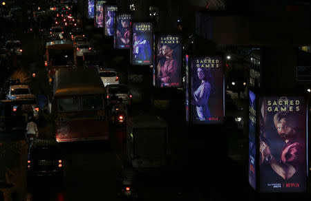 Traffic moves on a road past hoardings of Netflix's new television series "Sacred Games" in Mumbai, India, July 11, 2018. REUTERS/Francis Mascarenhas