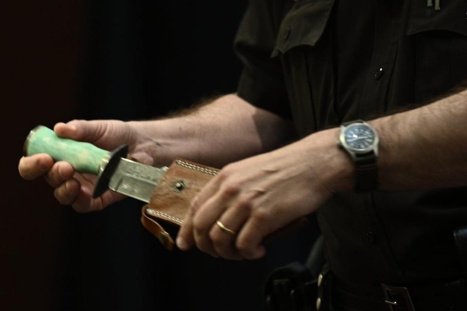 A Fairfax County Deputy Sheriff officer holds the knife that Amber Heard gifted to actor Johnny Depp (EPA)