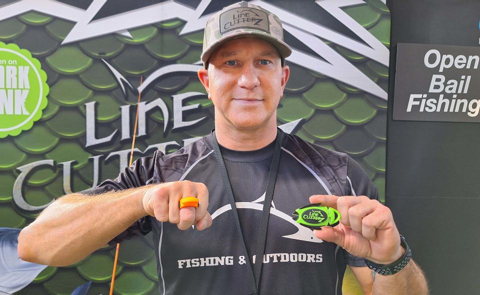 Darran Greene of Line Cutterz shows two of the designs anglers can use to trim their fishing line at the Great American Outdoor Show in Harrisburg.