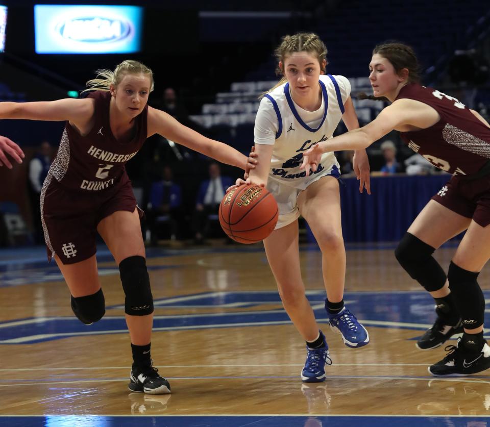 Simon Kenton’s Anna Kelch dribbles between Henderson’s Mallorie Veal and Brooklyn Gibson in the 2023 Mingua Beef Jerky Girls’ Sweet 16 at Rupp Arena.March 9, 2023