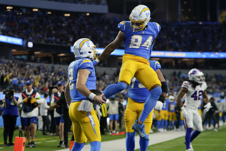 Los Angeles Chargers quarterback Easton Stick (2) celebrates his rushing touchdown with tight end Stone Smartt (84) during the first half of an NFL football game against the Buffalo Bills, Saturday, Dec. 23, 2023, in Inglewood, Calif. (AP Photo/Ryan Sun)