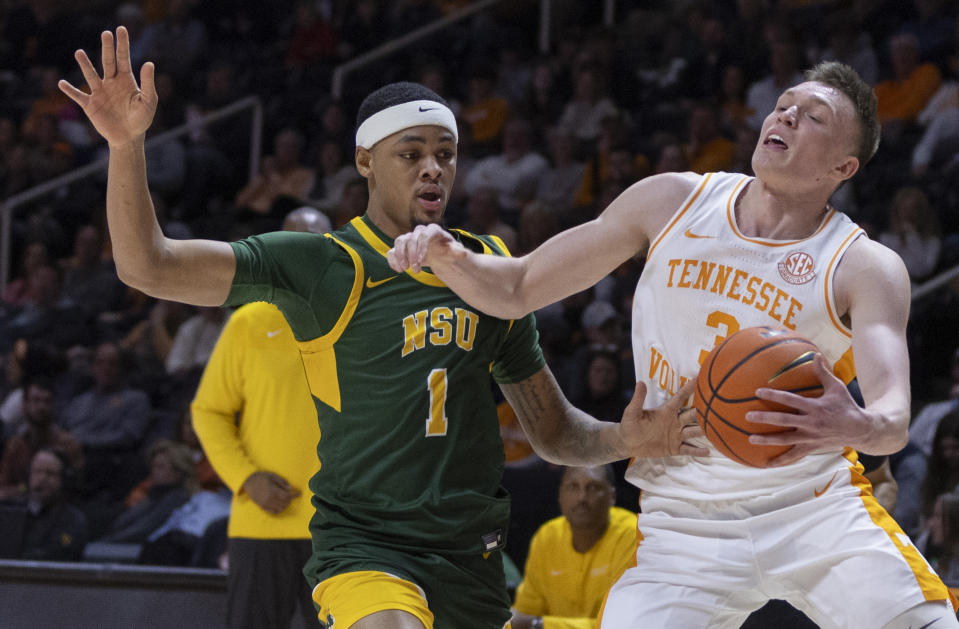 Tennessee guard Dalton Knecht (3) is fouled by Norfolk State guard George Beale Jr. (1) during the first half of an NCAA college basketball game Tuesday, Jan. 2, 2024, in Knoxville, Tenn. (AP Photo/Wade Payne)