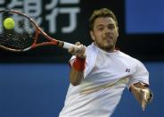 Stanislas Wawrinka of Switzerland hits a return to Rafael Nadal of Spain during their men's singles final match at the Australian Open 2014 tennis tournament in Melbourne January 26, 2014. REUTERS/Jason Reed