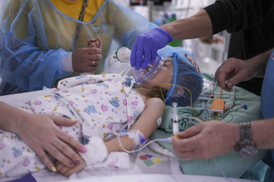 Karina Andreiko, a 5-year-old Ukrainian girl, is prepped for heart surgery by a team led by Dr. Sagi Assa, head of invasive pediatric cardiology, from the Save A Child's Heart non-profit organization, at the Wolfson Medical center in Holon, near Tel Aviv, Israel, Monday, May 2, 2022. Andreiko, received treatment in Israel for a heart defect that she would not have in her war-ravaged home country. (AP Photo/Ariel Schalit)