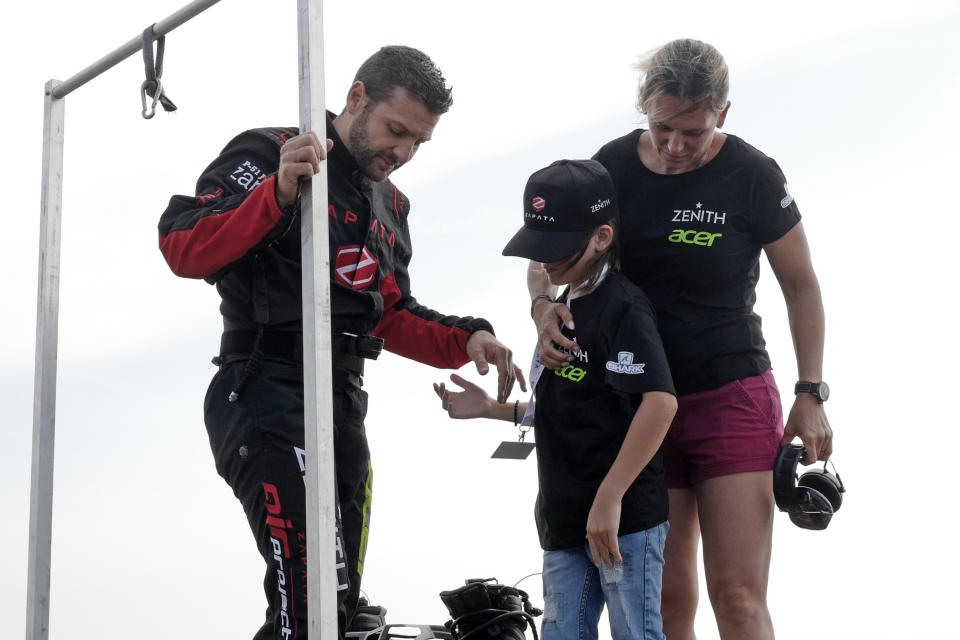 Franky Zapata, "Le Rocketman", a 40-year-old inventor, and his wife Krysten are photographed after a training flight over the Saint Inglevert airport near Calais, Northern France, Wednesday July 24, 2019. On Thursday, Zapata will attempt to fly into the record books by becoming the first person in human history to zoom across the Channel aboard a jet-powered 'hover-board'. (AP Photo/Michel Spingler)