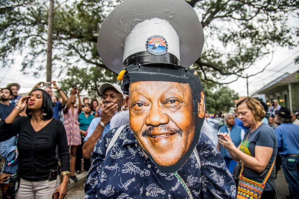 Fans parade down Poland Avenue toward the former home of music legend Antoine ‘Fats’ Domino during a second line parade honoring him on Nov. 1, 2017, in New Orleans. The New Orleans street where Domino, one of the founders of rock ‘n’ roll spent most of his life, is being renamed in his honor. (Photo by Amy Harris/Invision/AP, File)