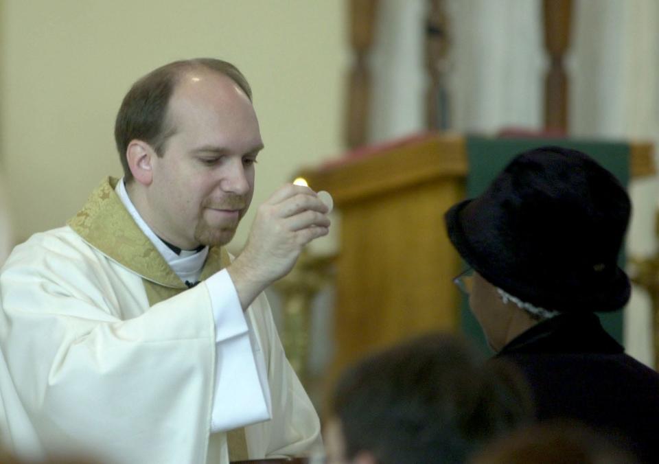 Father Mike Zacharias conducts Mass at Mansfield's St. Peter's Catholic Church in 2014.