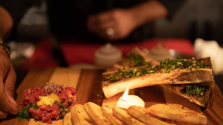 Server at Fleming's preparing plate