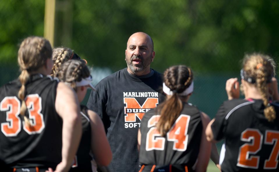 Marlington softball head coach Joe Tagliarini talks to his players before they take the field against Canfield in the Division II regional final, Friday, May 26, 2023, at Nordonia.