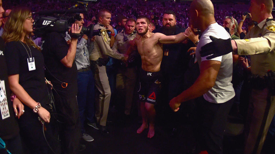 Khabib Nurmagomedov is escorted out of the arena. (Photo by Harry How/Getty Images)