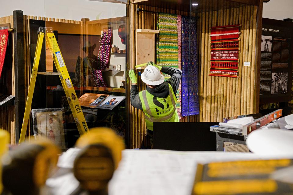 A crew member works on an exhibit featured in the museum at the Blessed Stanley Rother Shrine in Oklahoma City.