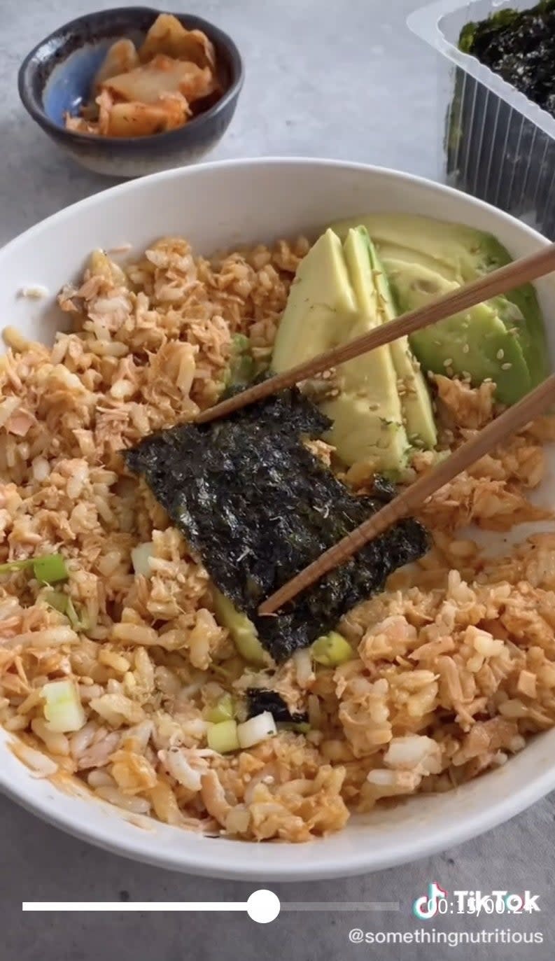 A bowl of salmon rice with kelp and scallions