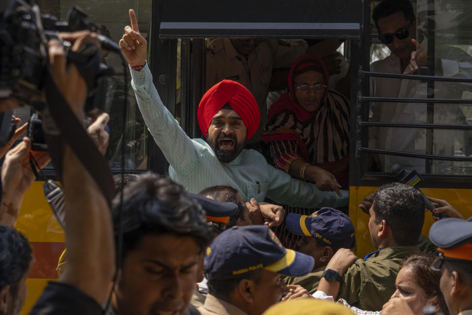 A member of opposition Congress party shouts slogans as police detains dozens who were demanding an investigation into allegations of fraud and stock manipulation by India's Adani Group during a protest outside National Stock Exchange in Mumbai, India, Wednesday, March 1, 2023. The Adani Group suffered a massive sell-off of its shares after a U.S.-based short-selling firm, Hindenburg Research, accused it of various fraudulent practices. The Adani Group has denied any wrongdoing. (AP Photo/Rafiq Maqbool)