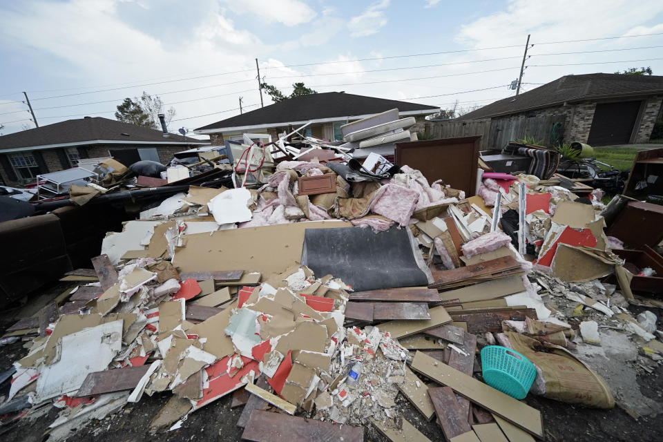 Debris piles up at curbside as residents gut their flooded homes in the aftermath of Hurricane Ida in LaPlace, La., Tuesday, Sept. 7, 2021. (AP Photo/Gerald Herbert)