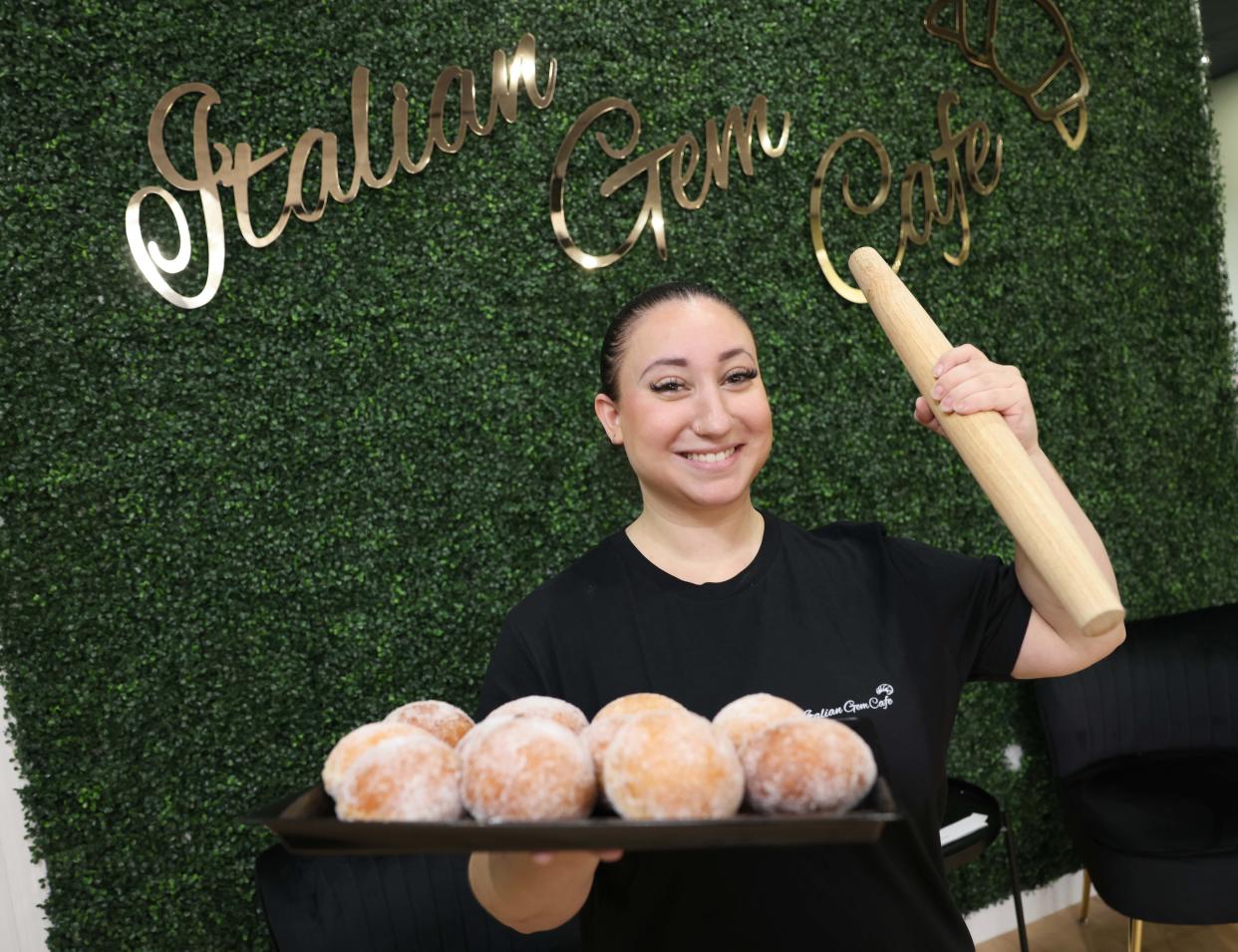 Jessica Gemma, owner of Italian Gem Cafe, with a tray of Bomboloni pastry on Friday, Nov. 10, 2023.