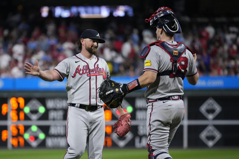 Atlanta Braves' Kirby Yates celebrates with Sean Murphy after the Braves clinched their sixth consecutive NL East title by defeating the Philadelphia Phillies in a baseball game, Wednesday, Sept. 13, 2023, in Philadelphia. (AP Photo/Matt Slocum)
