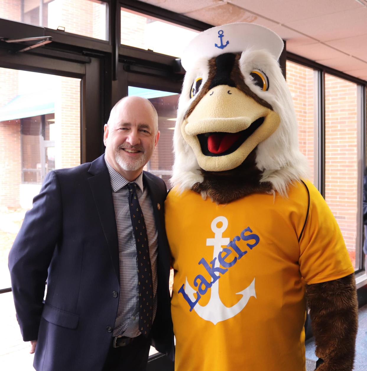 Incoming LSSU president David Travis shows school pride with the Lakers mascot.