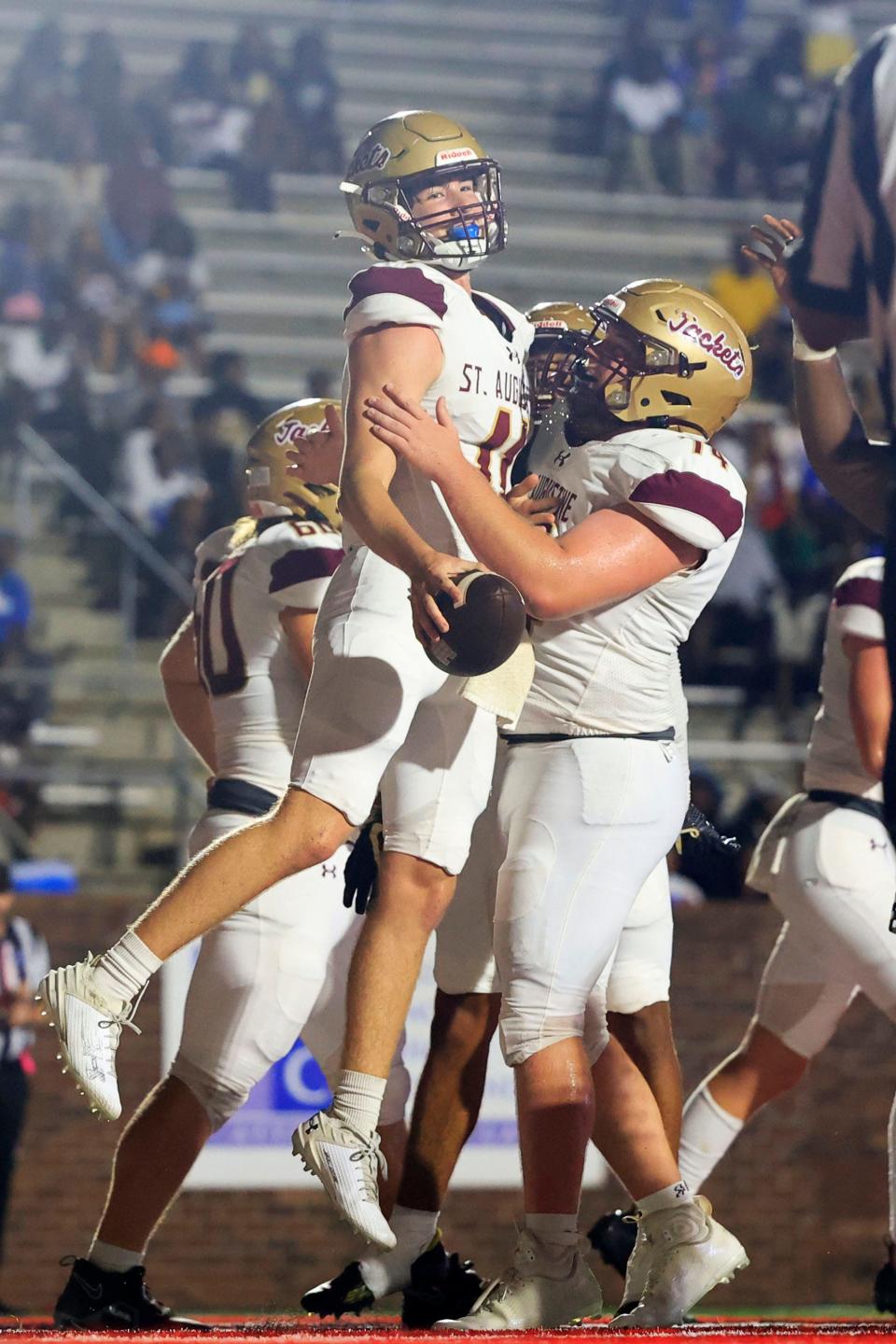 St. Augustine's Nick Miller (74) lifts St. Augustine's Locklan Hewlett (11) for scoring a rushing touchdown during the first quarter of the Florida-Georgia Border Classic high school football matchup Saturday, Sept. 9, 2023 at Glynn County Stadium in Brunswick, Ga. The St. Augustine Yellow Jackets held off the Brunswick Pirates 45-35.