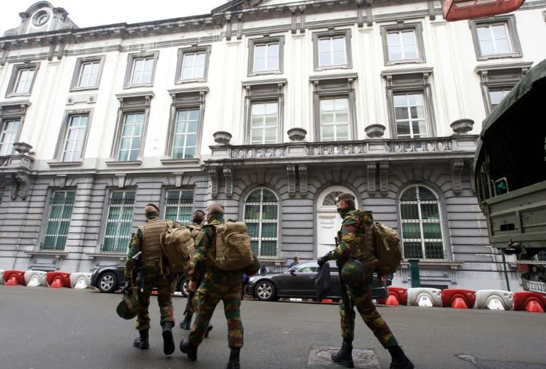 Belgian soldiers walk the streets after the dismantling of a new terrorist unit last night, in Brussels on June 18, 2016