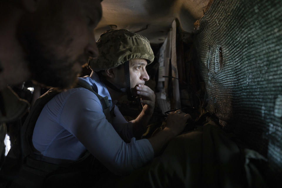 Ukrainian President Volodymyr Zelenskiy looks at the front line position from a shelter as he visits the war-hit Luhansk region, eastern Ukraine, Monday, May 27, 2019. (Ukrainian Presidential Press Office via AP)