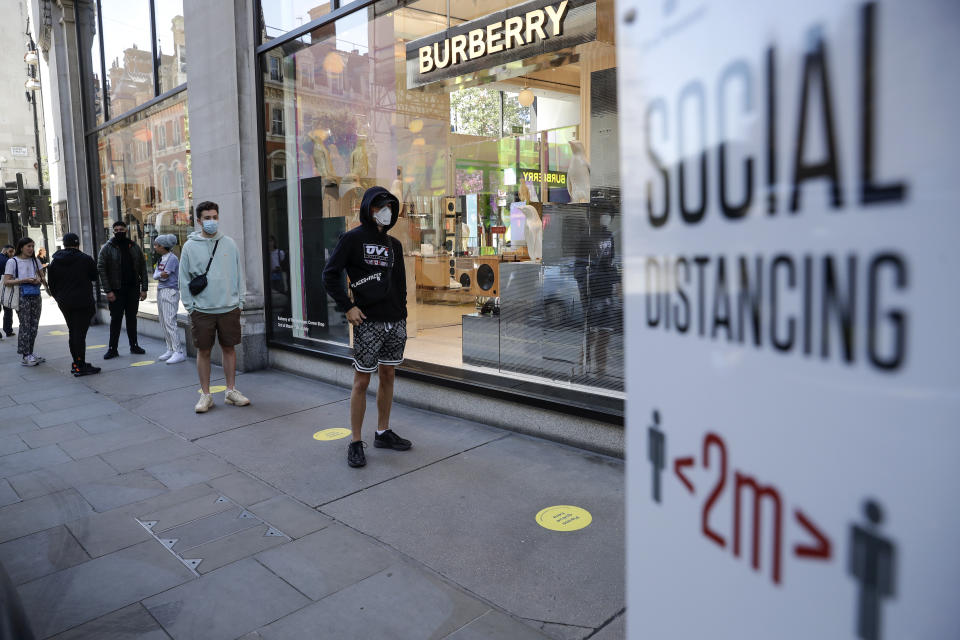 People wait in line for the opening of the Selfridges department store in London on Monday.