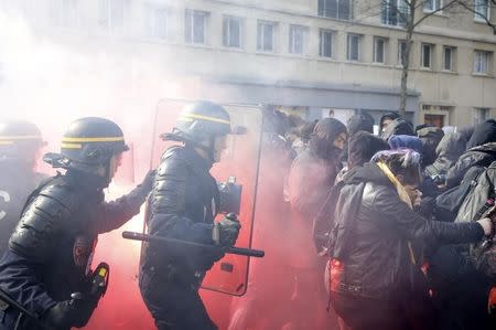 French CRS riot police clash with French high school and university students during a demonstration against the French labour law proposal in Paris, France, April 5, 2016 as the French Parliament will start to examine the contested reform bill. REUTERS/Pascal Rossignol