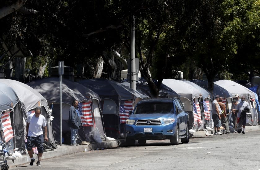 LOS ANGELES, CALIF. - JULY 4, 2020. American flags decorate tents at an encampment of homeless veterans along San Vicente Boulevard in Brentwood on Saturday, July 4, 2020. (Luis Sinco/Los Angeles Times)