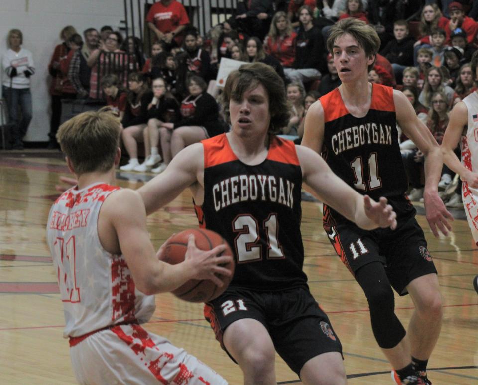 Cheboygan juniors Robert Godfrey (21) and Brennen Thater (right) attempt to trap Onaway junior Jackson Chaskey (left) during the second half of Friday night's matchup.