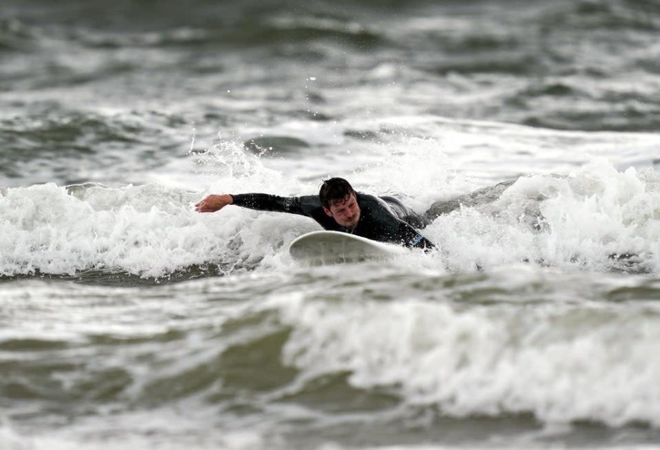 A surfer in Porthcawl (Steve Parsons/PA) (PA Archive)