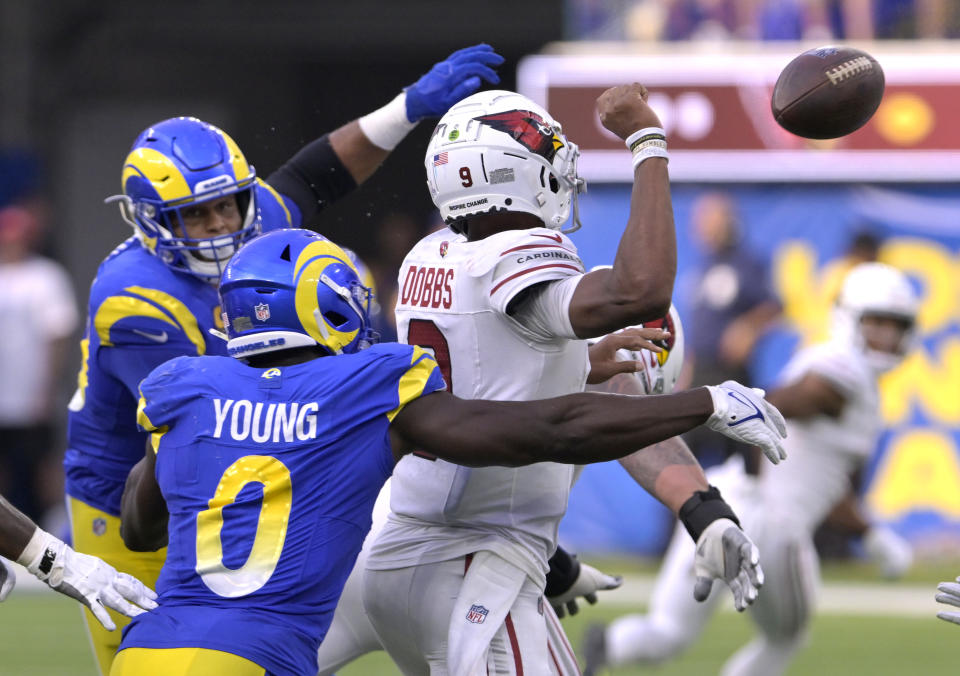 Oct 15, 2023; Inglewood, California, USA; Los Angeles Rams linebacker Byron Young (0) knocks the ball out of the hands of Arizona Cardinals quarterback Joshua Dobbs (9) to force a fumble recovered by the Arizona Cardinals during the second half at SoFi Stadium. Mandatory Credit: Alex Gallardo-USA TODAY Sports