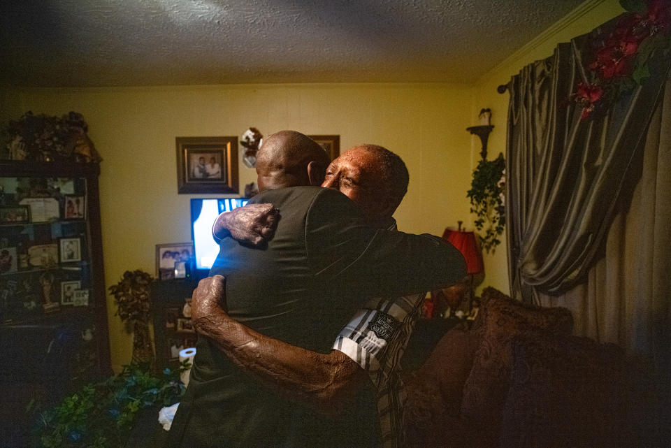 Crump hugs Curtis Jones, a client who was severely burned after an explosion at a manufacturing facility supplying the Department of Defense, at home in Tallahassee, Fla., on April 3.<span class="copyright">Ruddy Roye for TIME</span>