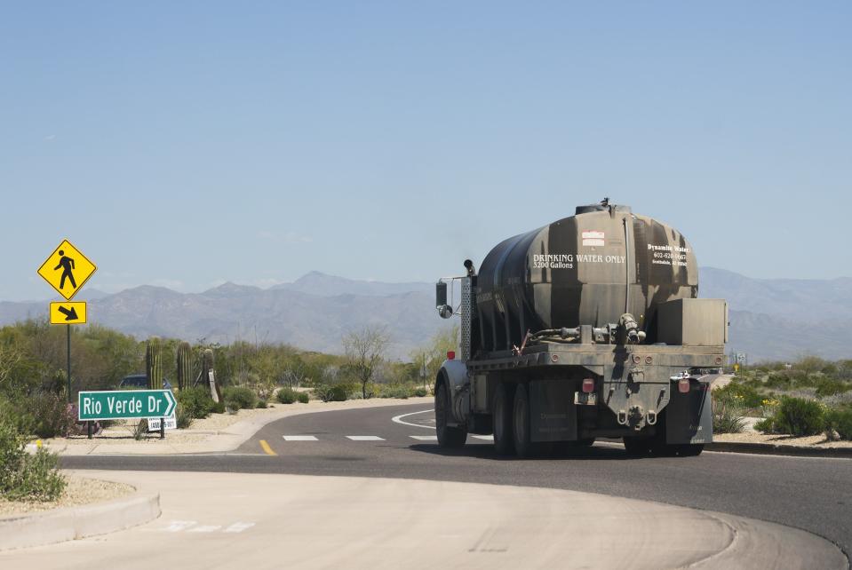 A Dynamite Water hauler takes a roundabout on Rio Verde Drive after leaving EPCOR's New River/Desert Hills hauling station. The truck delivered water to a residence in the Rio Verde Foothills on April 11, 2023.