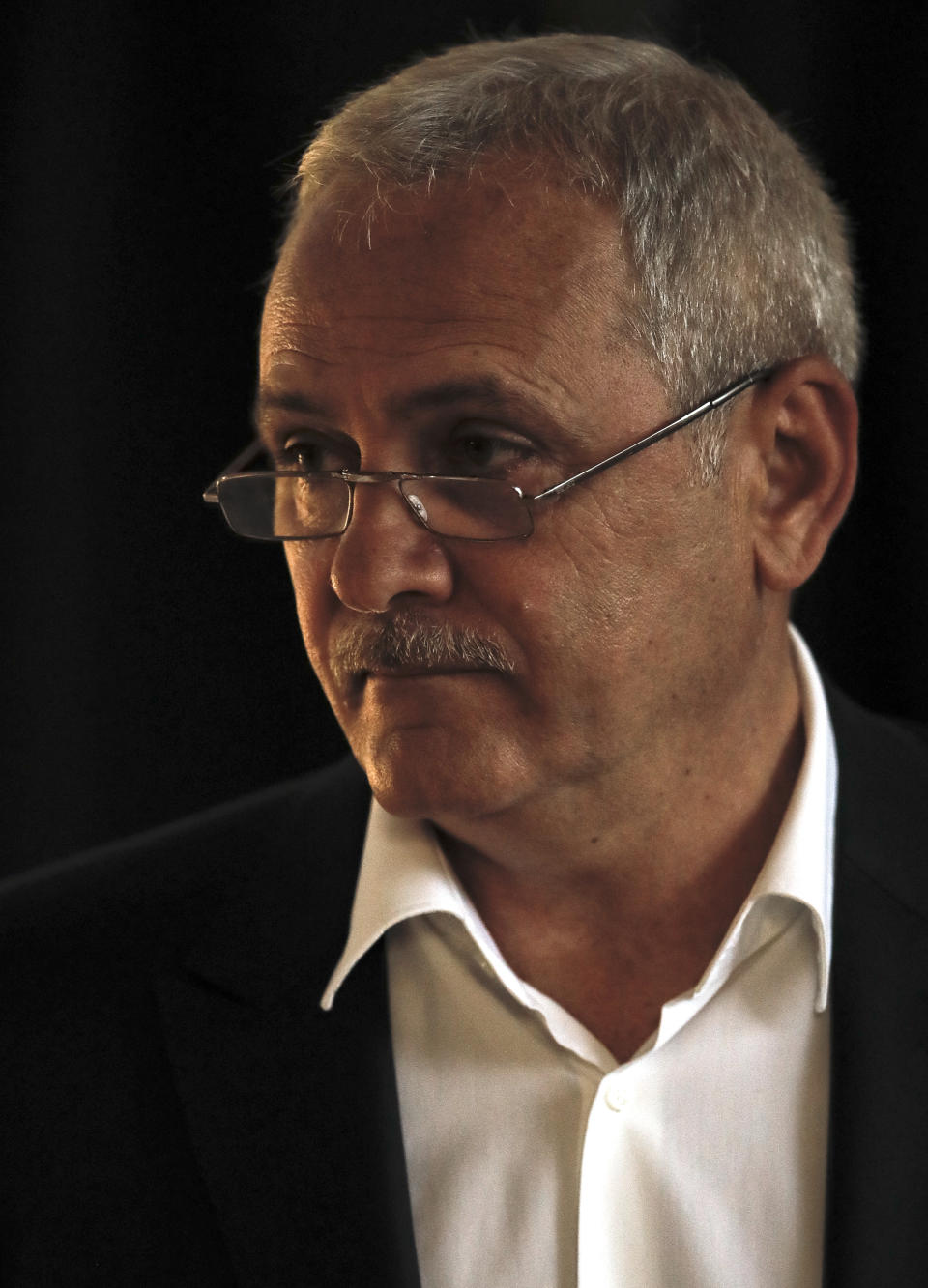 FILE- In this Sunday, May 26, 2019, file photo Liviu Dragnea, the head of the ruling Social Democratic party waits to cast his vote in the European Parliament elections, in Bucharest, Romania. The High Court for Cassation and Justice has sentenced Dragnea to serve 3 and a half years in prison for intervening from 2006-2012 to keep two women on the payroll of a family welfare agency, even though they were working for his party instead. (AP Photo/Vadim Ghirda, File)