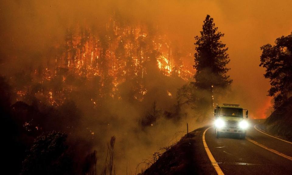 A firetruck drives along California Highway 96 as the McKinney Fire burns in July