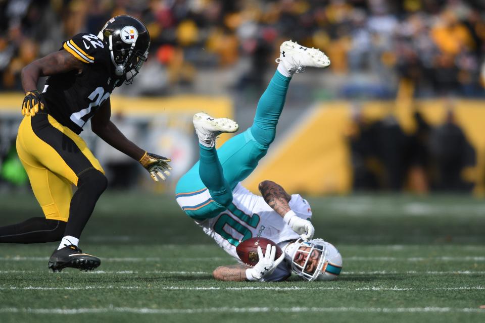 <p>Miami Dolphins wide receiver Kenny Stills (10) catches a pass in front of Pittsburgh Steelers cornerback William Gay (22) during the first half in the AFC Wild Card playoff football game at Heinz Field. Mandatory Credit: James Lang-USA TODAY Sports </p>