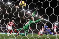 Chelsea's John Terry (2nd R) scores the opening goal past Stoke City's Asmir Begovic (C) during their English Premier League soccer match at the Britannia Stadium in Stoke-on-Trent, northern England December 22, 2014. REUTERS/Darren Staples