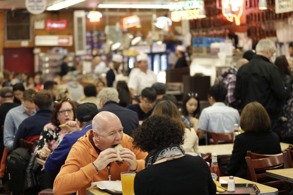 FILE - In this May 11, 2017, file photo, diners enjoy eating at Katz's Delicatessen in New York. With New York City at the epicenter of the coronavirus outbreak in the U.S. and its native-born among those offering crucial information to the nation in televised briefings, the New York accent has stepped up to the mic — or maybe the megaphone. (AP Photo/Seth Wenig, File)