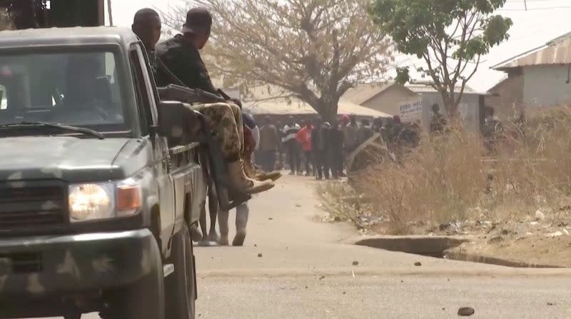 Security personnel patrol the streets amid a surge in violence in Mangu