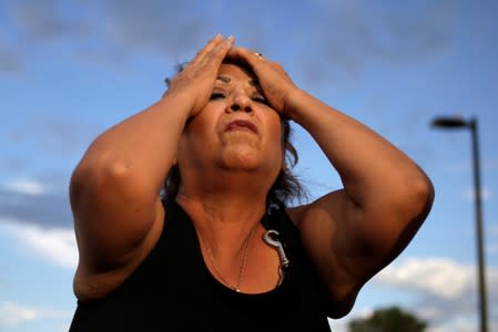 A woman reacts after a mass shooting at a Walmart in El Paso