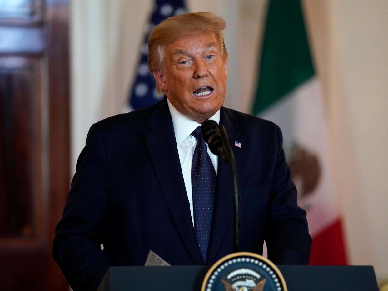 President Donald Trump delivers a statement before a dinner at the White House on Wednesday 8 July 2020: Evan Vucci/AP