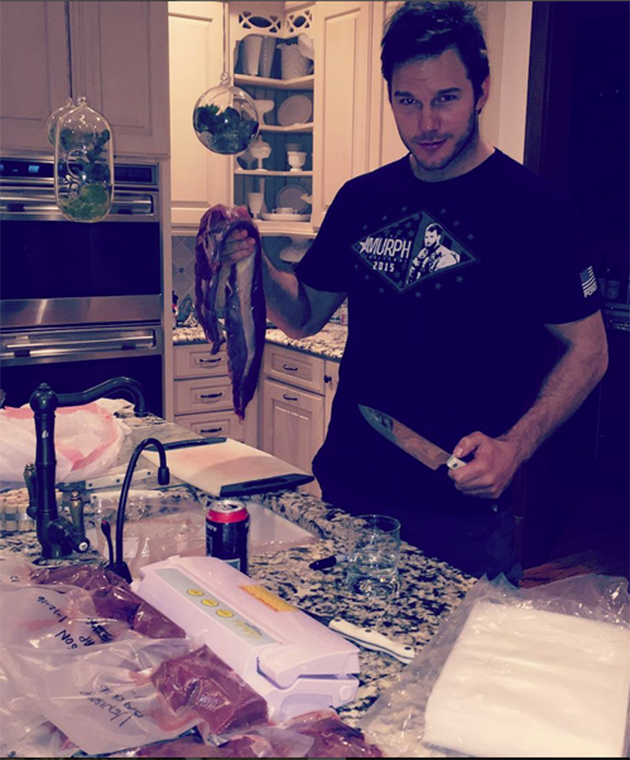 Chris Pratt holds up meat from an 