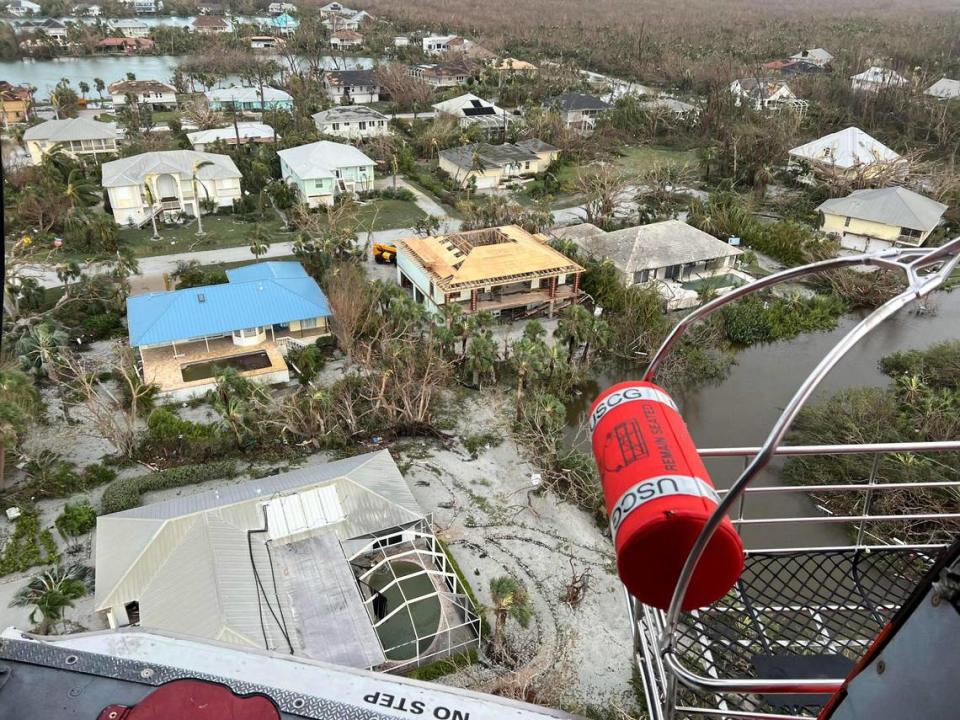 U.S. Coast Guard aircrew hoists people from flooded areas near Sanibel, Florida in the wake of Hurricane Ian, Sept. 29, 2022. Crews continue to conduct search and rescue operations in affected areas.