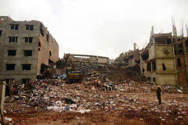 Excavators clear debris at the site of the eight-storey building collapse in Savar outside Bangladesh's capital Dhaka, May 4, 2013. The death toll from Bangladesh's worst industrial disaster surpassed 600 Sunday after dozens of bodies were pulled from the wreckage of a nine-storey building housing garment factories, the army said